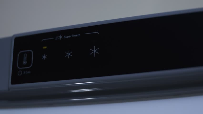 Alert indicator blinking on a touch panel of the freezer