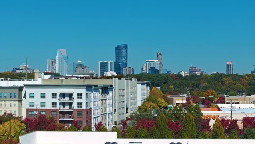 Buckhead, Atlanta, Georgia, United States of America - Mid-rise Apartments and Colorful Autumn Trees Sit in the Foreground, with Buckhead’s Modern Skyline Rising Sharply Behind them - Static Shot
