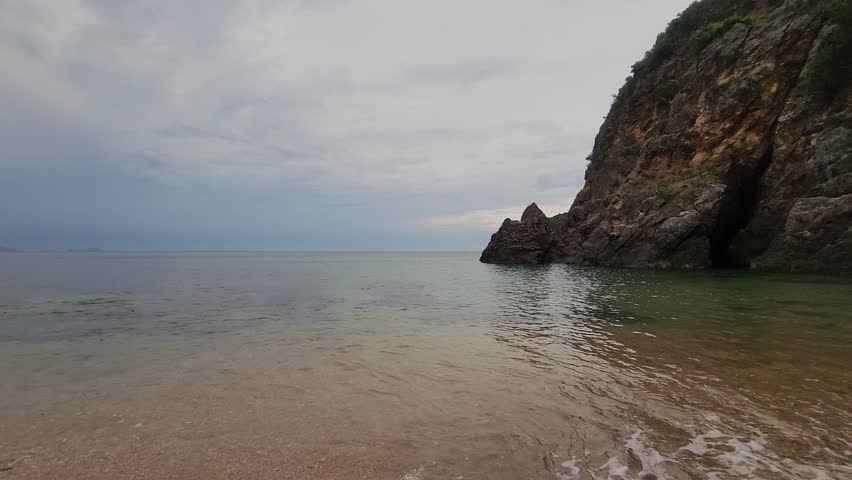 Powerful Ocean Waves Crashing Against Rugged Rocky Coast