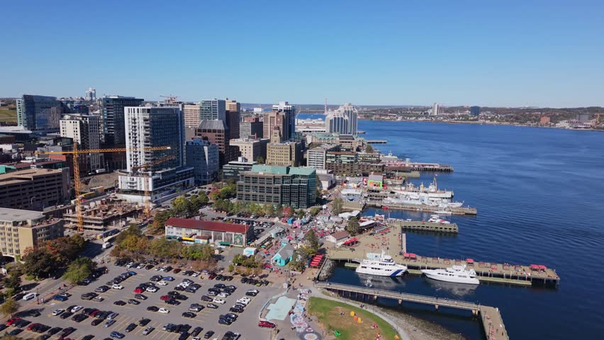 Aerial Scene Displays Halifax Nova Scotia Canada With Sunlit Skyscrapers Marina Yachts And Tourists Walking Along The Waterfront On A Clear Summer Day Creating A Beautiful Coastal Atmosphere