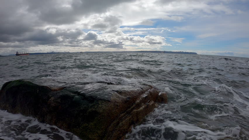Salish Sea Storm Waves and Rocks 4K UHD.Waves crash in slow motion on the rocky shoreline of English Bay. Vancouver, British Columbia, Canada. 4K UHD.

