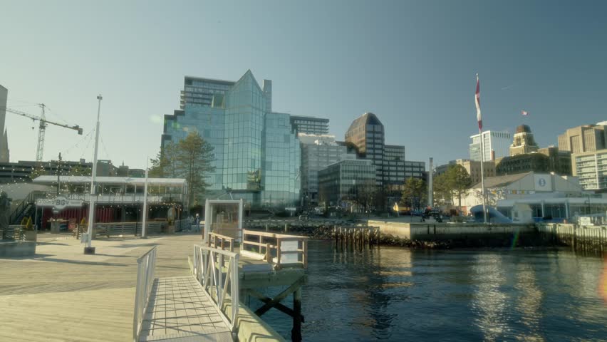 Halifax Nova Scotia Waterfront With Modern Skyscrapers Yachts Docked In The Harbor And Tourists Enjoying The Sunny Summer Weather Along The Busy Coastal Boardwalk
