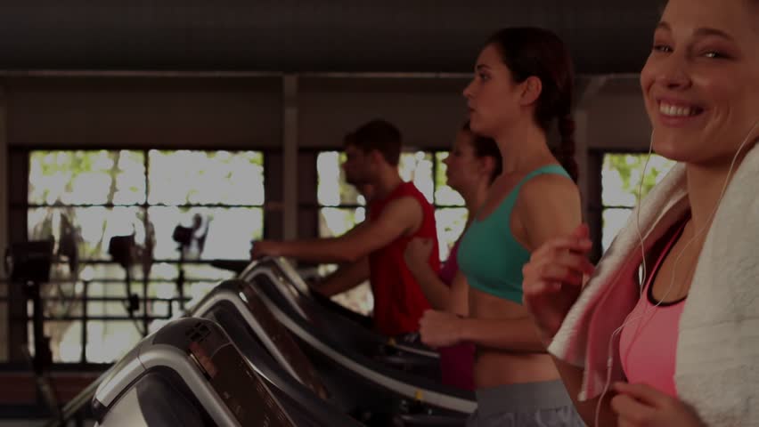 Woman jogging treadmill, camera moving causing HUD slide and stock line rising, tracking stocks. Cardio, fitness, gym, athlete, motion, parallax, filmgrain