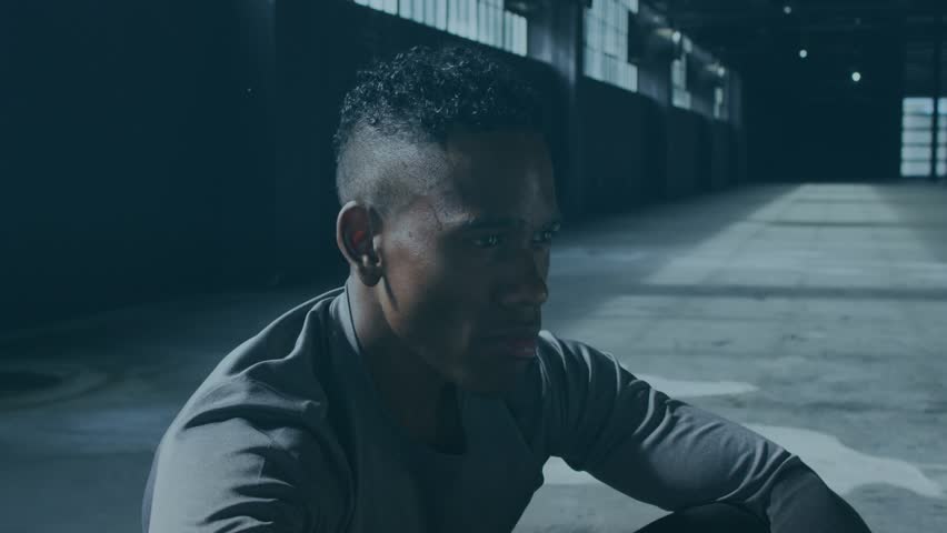 Fatigued fitness athlete warehouse grabbing bottle, pouring water on head to cool, helix overlaying. Endurance, exertion, workout, industrial, daylight, sweat, droplets