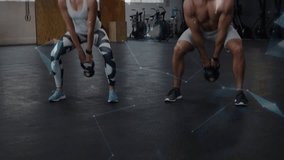 Fitness duo starting hip-hinge and swinging kettlebells, training while overlay highlighting reps. Partners, synchronized, coordination, athletes, gym, weights, rings - Powered by Shutterstock - Get 15% off with code: PIKWIZARD15