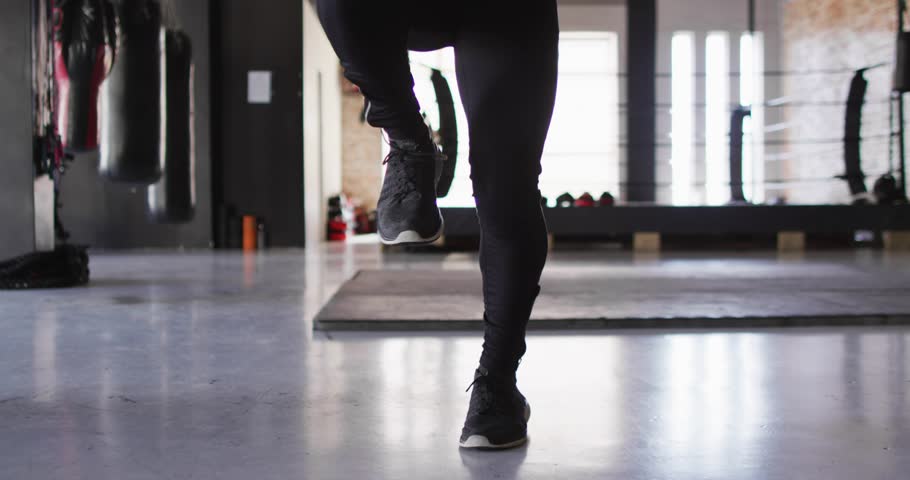 Male trainee doing high knees for fitness, swinging rope into jump rope, charts overlaying rhythm. Athlete, promo, dynamic, gym, studio, endurance, focus