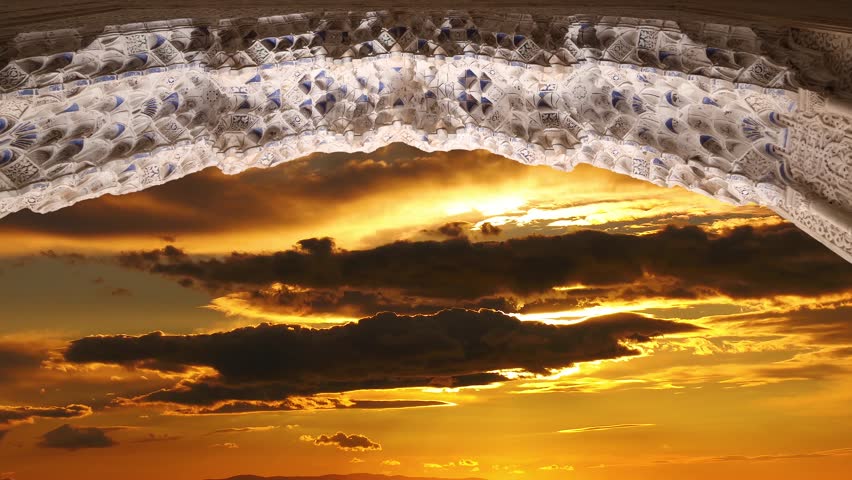 Arches in Islamic (Moorish)  style (against the sunset) in Alhambra, Granada, Spain. 4K, time lapse, with zoom 