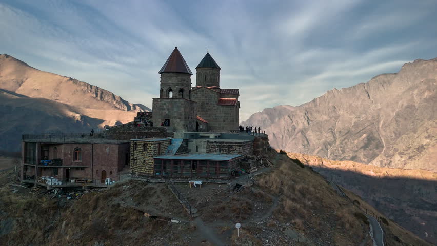 The Church of the Holy Trinity (Gergeti) with a view of Mount Kazbek, in the village of Stepantsminda, Georgia