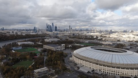 Drone Flying Forward over City Stadium Skyline