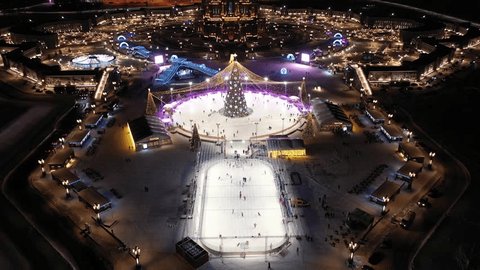 Drone Descending toward Illuminated Winter Skating Park