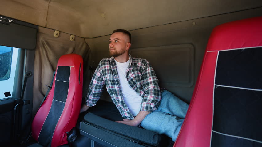 Tired truck driver taking a nap in his lorry cabin