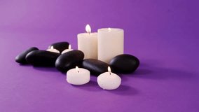 Decorative spa candles and stones flickering causing mist drifting in to veil front and evoke calm. Tabletop, pebbles, purple, minimalist, ambient, tranquil, wellness - Powered by Shutterstock - Get 15% off with code: PIKWIZARD15