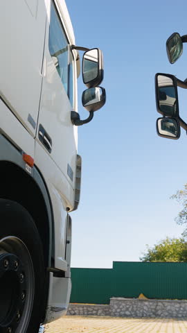 Professional truck driver getting into a semi trailer cab. Right hand drive car