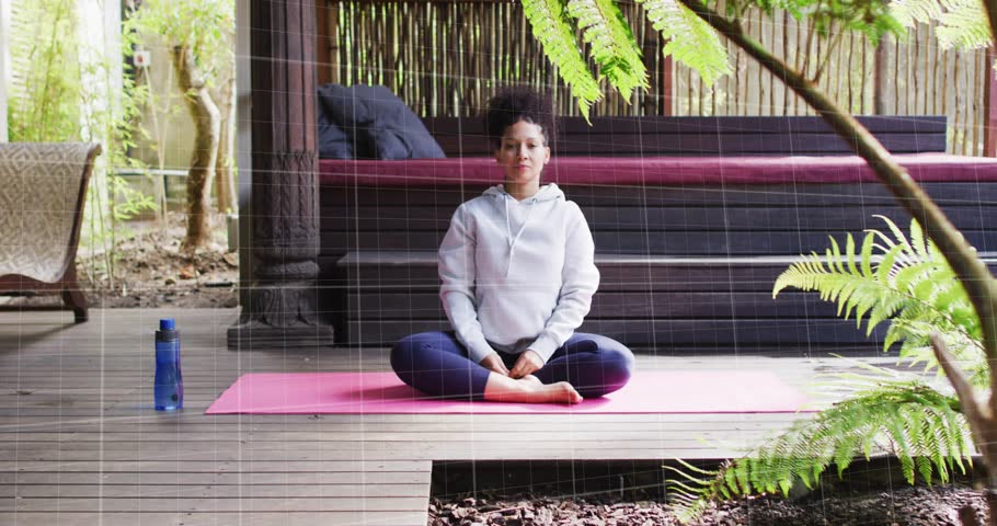Woman moving from lap, doing side stretch on pink mat for fitness, grid and red-zigzag expanding. Yoga, meditation, outdoor, garden, deck, serenity, balance