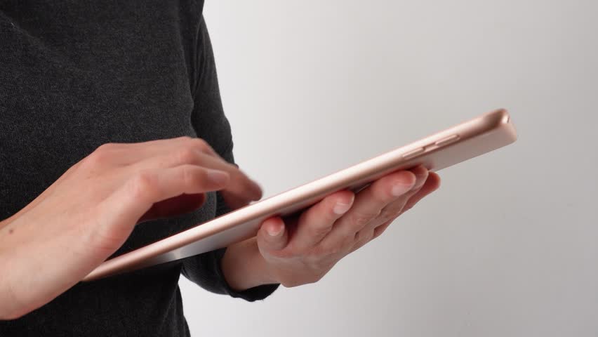 Unrecognizable woman interacting with a tablet