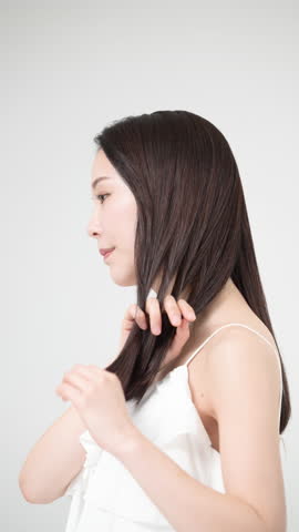 Beauty portrait, a woman with beautiful hair caring for her straight long hair Side profile video