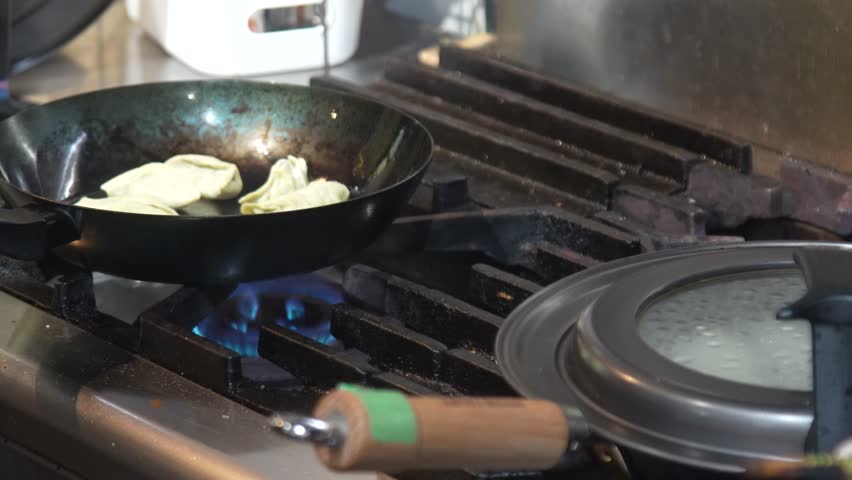 Image of a woman grilling dumplings