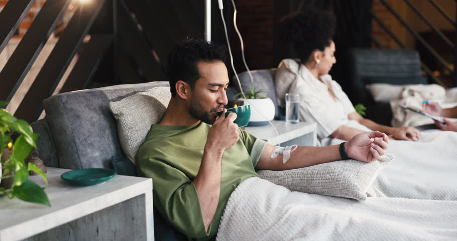 Coffee, iv drip and man with healthcare, vitamin b and supplements with antibiotics. Patient, caffeine and happy person with chemotherapy, espresso and electrolytes with medical service and wellness