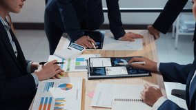 Corporate professionals collaborating on a business strategy, analyzing financial reports with charts and graphs on a digital tablet in the office - Powered by Shutterstock - Get 15% off with code: PIKWIZARD15