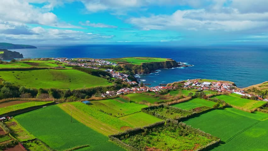 Aerial view of the beautiful coast of Sao Miguel island, Azores, Portugal, showing scenic cliffs with green fields above the Atlantic Ocean.