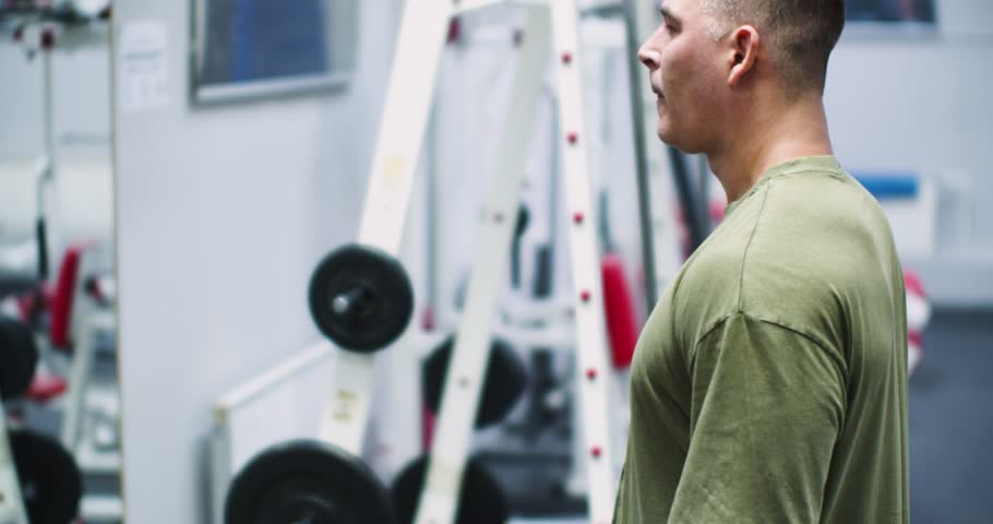 Dumbbell raises for the deltoid muscles. Deltoid workout. Caucasian man performs dumbbell raises, focusing on strengthening his deltoid muscles.