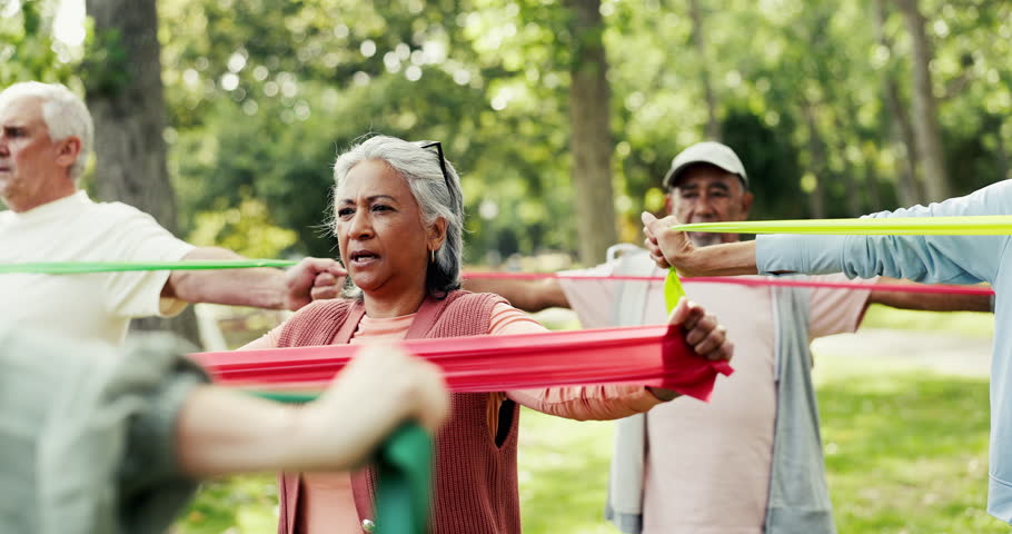 Personal trainer, park or senior people with resistance band, stretching workout or retirement health. Outdoor, muscle strength development or group with mobility training, exercise or fitness coach