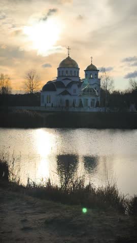 Orthodox church and lake at sunrise