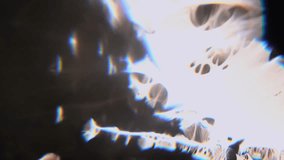 Abstract underwater footage featuring floating bubbles and prismatic light refraction creating rainbow chromatic aberration effects with dramatic contrast between dark water - Powered by Shutterstock - Get 15% off with code: PIKWIZARD15