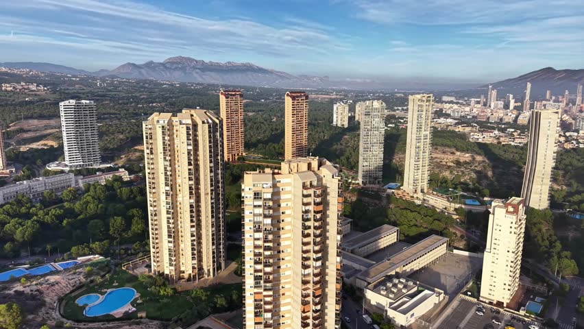 Urban Towers With Mountain Backdrop And Pines, Tall Residential Blocks Overlooking Green Valley, Distant Ridge