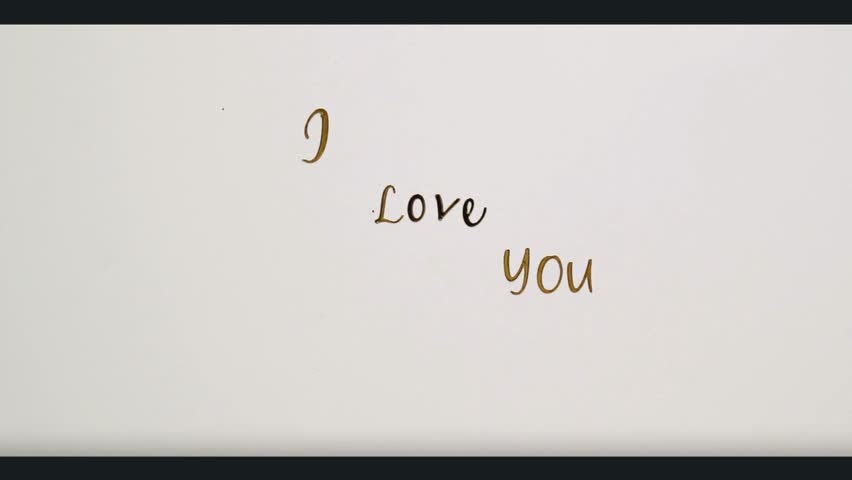 Elegant hand-drawn "I Love You" text on a white background, accompanied by golden moving confetti, perfect for romance and holidays.