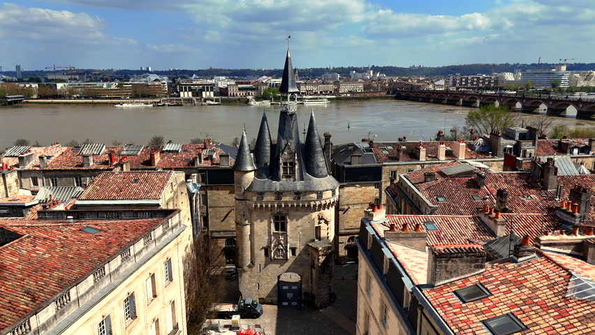 Close view of Porte Cailhau slate spires and wide riverside promenade Bordeaux