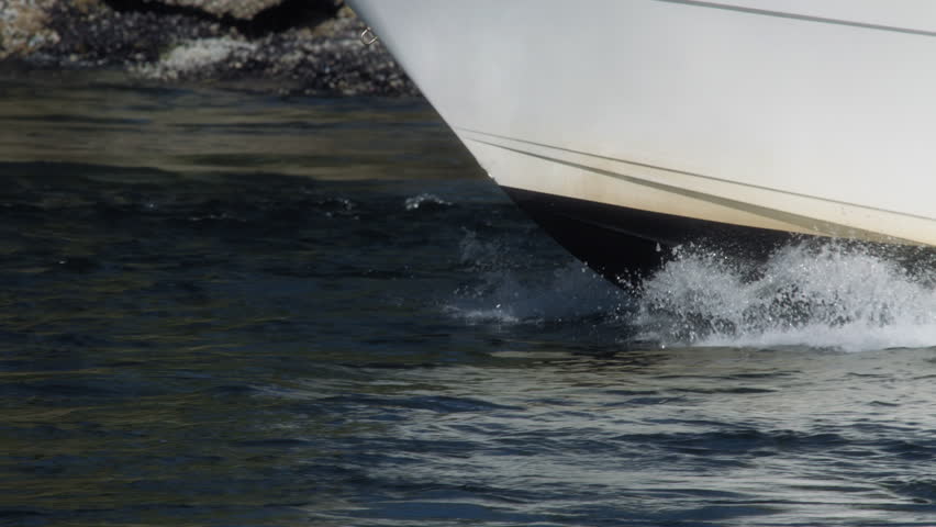 Close up of a yacht sailing through waters near Vancouver Island. Slow motion.