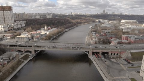 Drone Flying Backward Descending over River Bridge