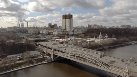 Drone Flying Diagonally Right over River Bridge