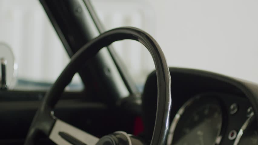 Old Alfa Romeo steering wheel with hands on it 4k