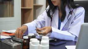 Asian female doctor using laptop for teleconsultation and checking patient's EHR record, wearing glasses,demonstrating modern healthcare,online medical services  professional expertise in hospital - Powered by Shutterstock - Get 15% off with code: PIKWIZARD15