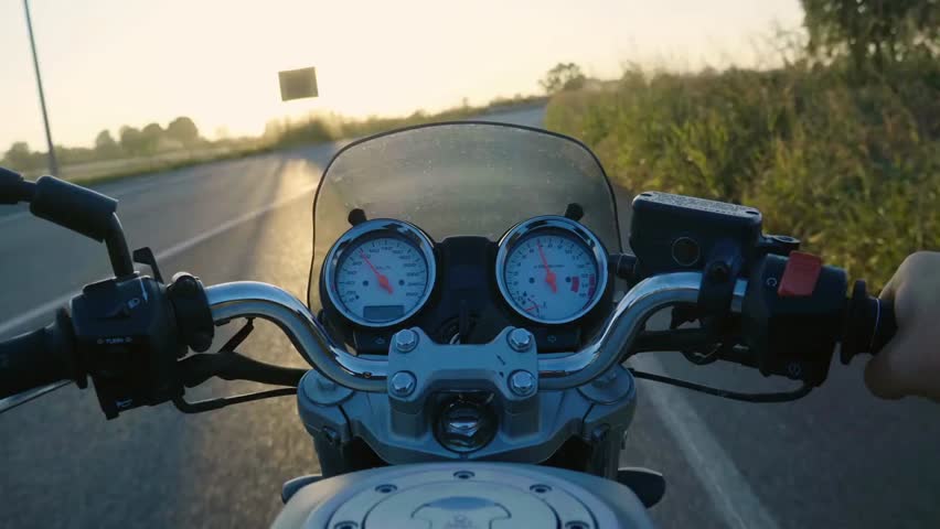 POV of motorcyclists riding on a scenic mountain highway, enjoying the road, adventure, and freedom of outdoor motorcycling experiences.