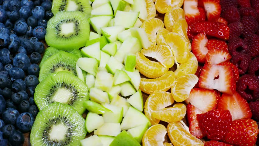 Vibrant mix of fresh and exotic fruits including strawberries, apples, blueberries, raspberries, kiwi, and orange, perfect for summer, health, and nutrition concepts.