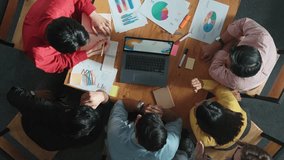 Top view of business team looking at laptop and analyzing chart. Close up of diverse group working on computer and reading financial report. Group of people explain idea at meeting. Convocation. - Powered by Shutterstock - Get 15% off with code: PIKWIZARD15