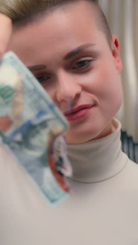 Caucasian female woman girl crazy burning money cash banknote finance spending laughing in white futuristic space lady laugh overspending financial budget crisis burn fire cyberpunk futurism gambling
