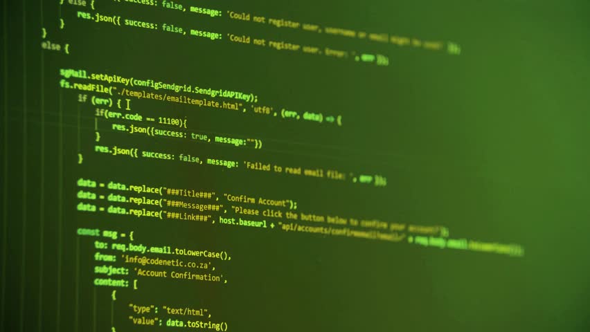 Close-up of coding on computer screen with green display, showcasing programming language and software development
