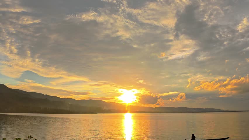 Sunset on the lake with a boat in the foreground