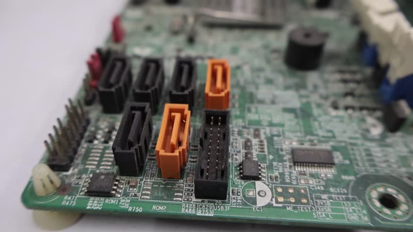 Close-up view of a computer motherboard highlighting the main power connector, RAM memory slots, and SATA ports for storage devices. This image represents essential PC hardware components used in desktop computers, ideal for technology concepts, computer repair, PC building, and IT education.