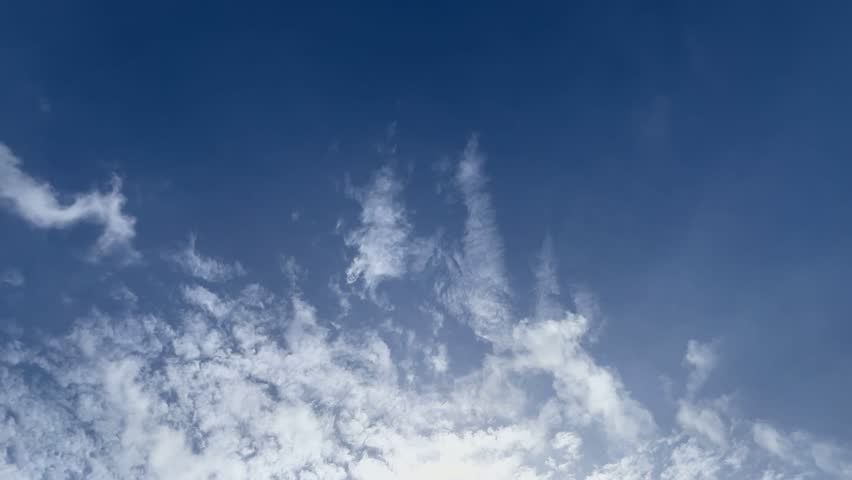 Lush green farmland with rolling hills under cloudy sky, rural agricultural landscape showing natural vegetation, open fields, and peaceful countryside atmosphere.