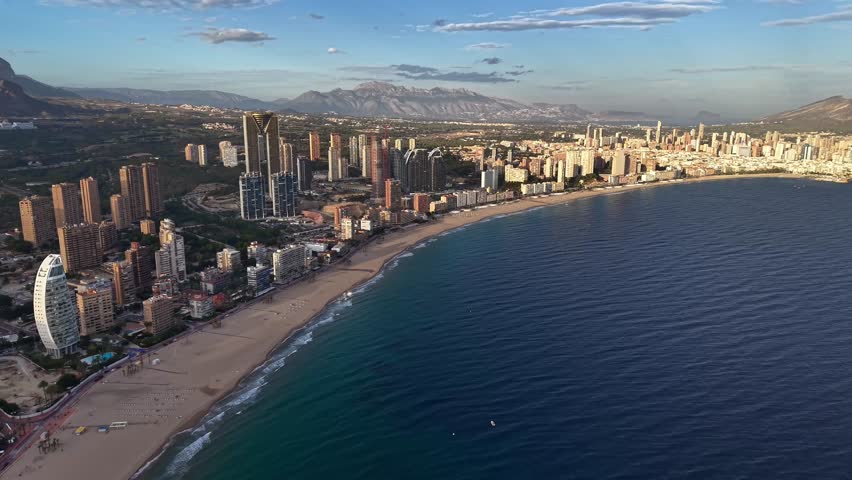 Aerial Luxury Beachfront At Sunrise With Calm Turquoise Water, Upscale Towers And Quiet Promenade, Golden
