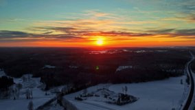 Drone panning over snowy countryside at sunrise with vivid sky and untouched winter fields. - Powered by Shutterstock - Get 15% off with code: PIKWIZARD15