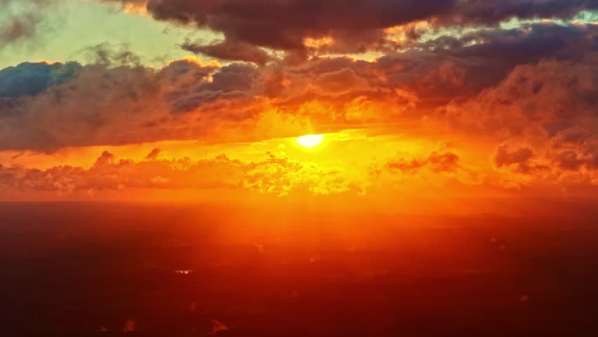 Fiery golden sunset above clouds capturing dramatic colors and stunning natural beauty