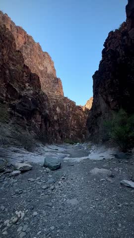 Hiking Through a Slot Canyon With Red Walls During Golden Hour (Big Bend Ranch State Park, Texas, USA)