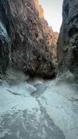 Hiking Through a Slot Canyon With Red Walls and White Rock Bottom (Big Bend Ranch State Park, Texas, USA)