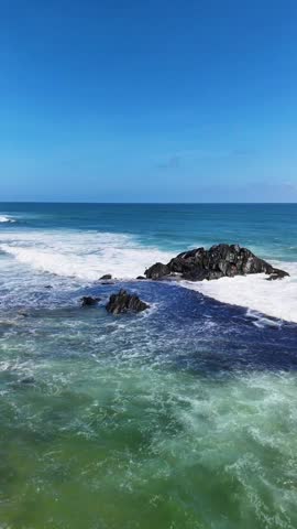 Scenic view of a rocky coastline where waves are crashing against the shore